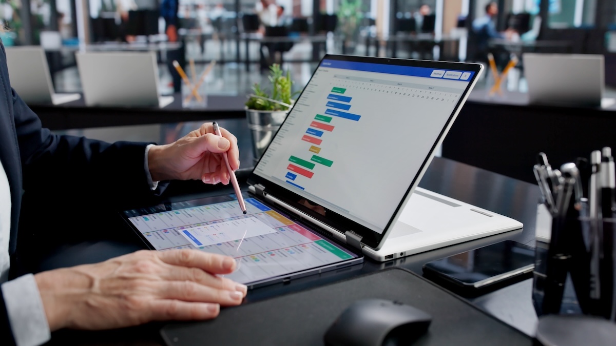 Project manager reviewing work schedules and resource planning on a digital dashboard.